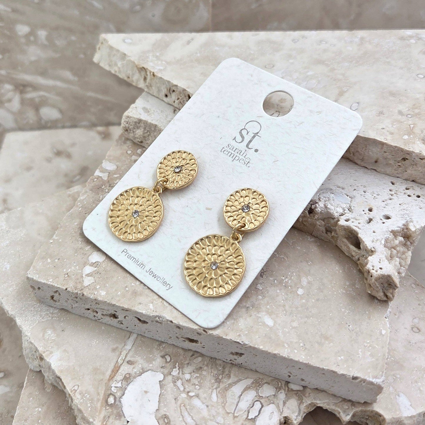 Dual disc imprinted earrings with central crystal